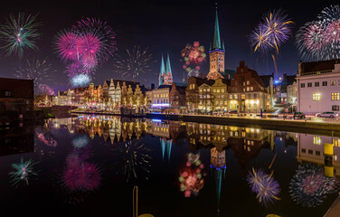 Fireworks in Lübeck skyline with cathedral and harbor, Lübeck, Germany. New Years Eve.