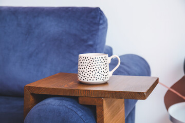 Armrest table on sofa in interior of room