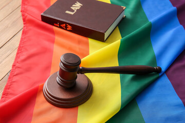 Rainbow LGBT flag with judge's gavel and law books