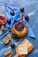 Composition with delicious homemade plum jam on table