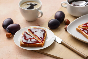 Slices of bread with delicious homemade plum jam on plate