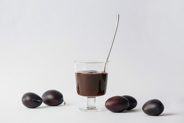 Bowl with delicious homemade plum jam on white background