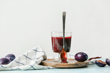 Bowl with delicious homemade plum jam on table