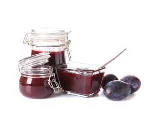 Glass jars with delicious homemade plum jam on white background