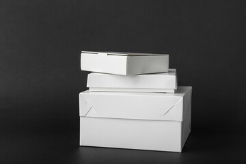 Blank cardboard boxes on dark background