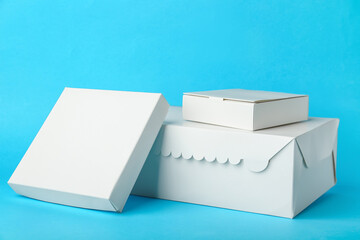 Blank cardboard boxes on color background