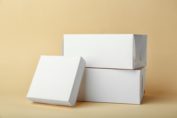 Blank cardboard boxes on color background