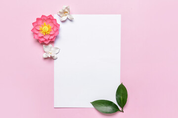 Blank paper sheet and flowers on color background