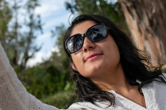 mujer joven tomando selfie con celular en el parque de la parroquia de santa maria magdalena en tepetlaoxtoc texcoco en el estado de mexico