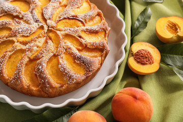 Plate with tasty peach pie, closeup