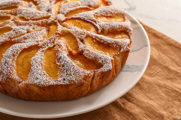 Plate with tasty peach pie, closeup
