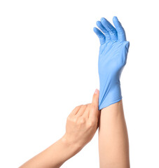 Woman taking off protective gloves on white background
