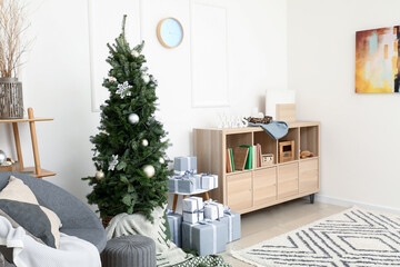 Interior of living room with beautiful Christmas tree and gift boxes