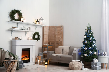 Interior of living room with beautiful Christmas tree and fireplace