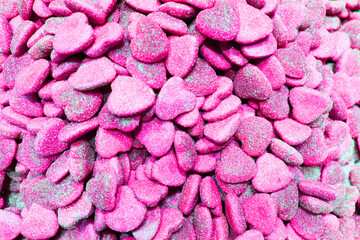 candy heart for Valentine's day. Candy A lot of sweets. Colorful texture using a background. Background rendering. Bright multiple jelly candies in powdered sugar. Confectionery wallpaper concept