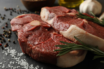 Tray with steak meat with herbs and spices, close up