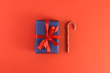 christmas gift on red background. Concept holiday atmosphere, new year, celebration, greeting card. Flatlay, top view