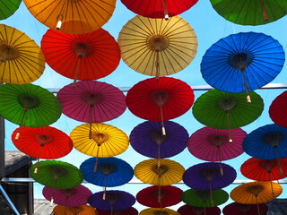 Fototapeta na wymiar Colorful fabric umbrella, Famous decoration item in festival or ceremony. Abstract idea of alternative sexual concept. 