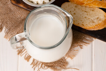 Milk, bread and cottage cheese on table