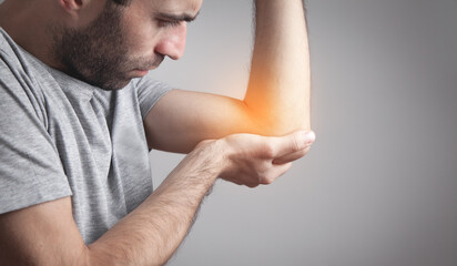 Caucasian man with elbow pain. Pain relief concept
