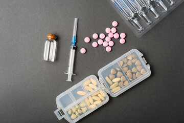 Fototapeta na wymiar Photo of medical tablets vitamins and syringe.