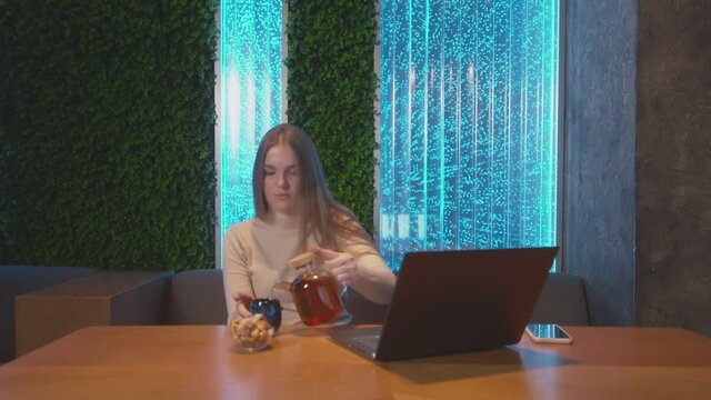 Young business woman sitting in cafe with laptop. Woman dring tea and working
