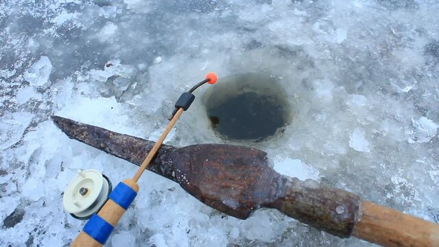 rod and gaff for winter fishing at the hole in the ice