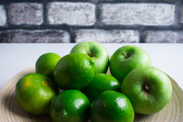 Lime, apple and tangerine. Green colored fruits.
