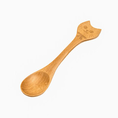 Wooden spoon with a handle in the form of a cat, isolated on a white background