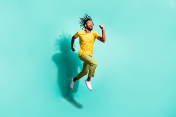 Fototapeta na wymiar Full size photo of young happy positive smiling cheerful african man running in air isolated on teal color background