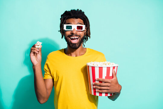 Photo Of Young Happy Positive Good Mood African Man Eating Popcorn Watch 3-D Movie Isolated On Teal Color Background