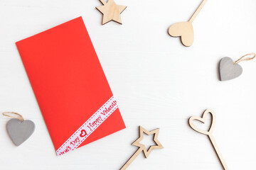 Valentine's Day accessories from natural materials and an envelope on a white background with space for text. Postcard template.