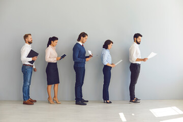 Job seekers applicants for vacancy standing in line with resumes and waiting for interview