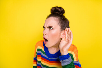 Photo of young girl shocked amazed hear listen gossip news fake novelty isolated over yellow color...