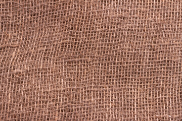 The texture of an uneven crumpled, roughly woven burlap.