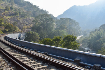 Fototapeta premium Indian railway Kerala tourism thenmala Kerala Tamilnadu railway line and caves and rocks tunnels village side 13 kannara bridge