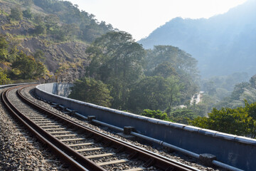Fototapeta premium Indian railway Kerala tourism thenmala Kerala Tamilnadu railway line and caves and rocks tunnels village side 13 kannara bridge