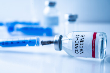 A single bottle vial of Covid-19 vaccine. Medical concept vaccination hypodermic injection...