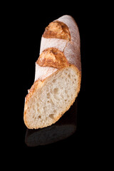 Freshly baked homemade bread isolated on black. French bread baguette. Healthy eating and traditional bakery, baking bread concept