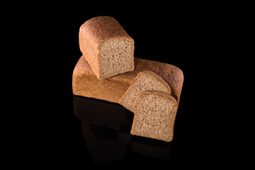 Freshly baked homemade bread isolated on black. Cut in half rye bread with slices. Healthy eating and traditional bakery, baking bread concept