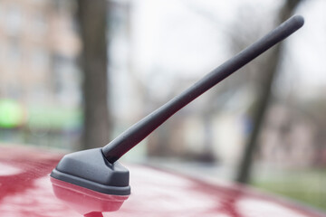 car antenna located on the roof of a red car