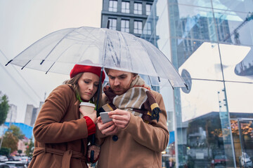 Frozen girl holding warm coffee and bonding to her lovely husband
