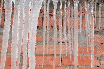 Long thick icicles hanging from the roof