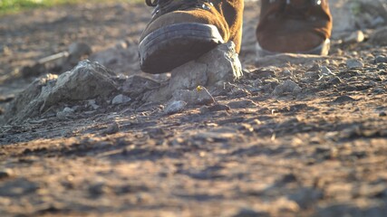 Tourist Wearing Trekking Shoes Walking in Rocky Mountains at Sunrise
