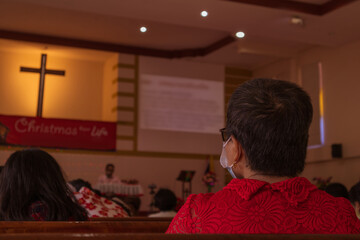 People go to church for Sunday prayers.people pray in the church.people wearing masks, praying, and standing apart,newnormal,socialdistancing,Coronavirus outbreak and coronaviruses influenza.