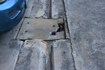 Broken reinforced concrete drain cover