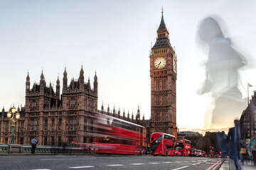 Fototapeta na wymiar Big Ben with red buses on the bridge in the evening, London, England, United Kingdom