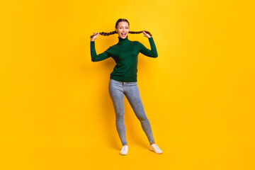 Fototapeta na wymiar Photo portrait full body view of woman holding two tails isolated on vivid yellow colored background