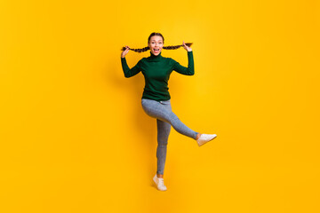 Fototapeta na wymiar Full length body size photo childish playful girl dancing relaxing on weekend enjoying music isolated on vibrant yellow color background
