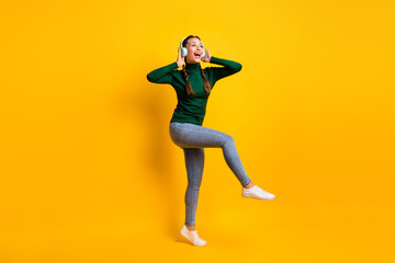 Fototapeta na wymiar Full length body size photo overjoyed girl listening music singing song dancing party isolated on vibrant yellow color background